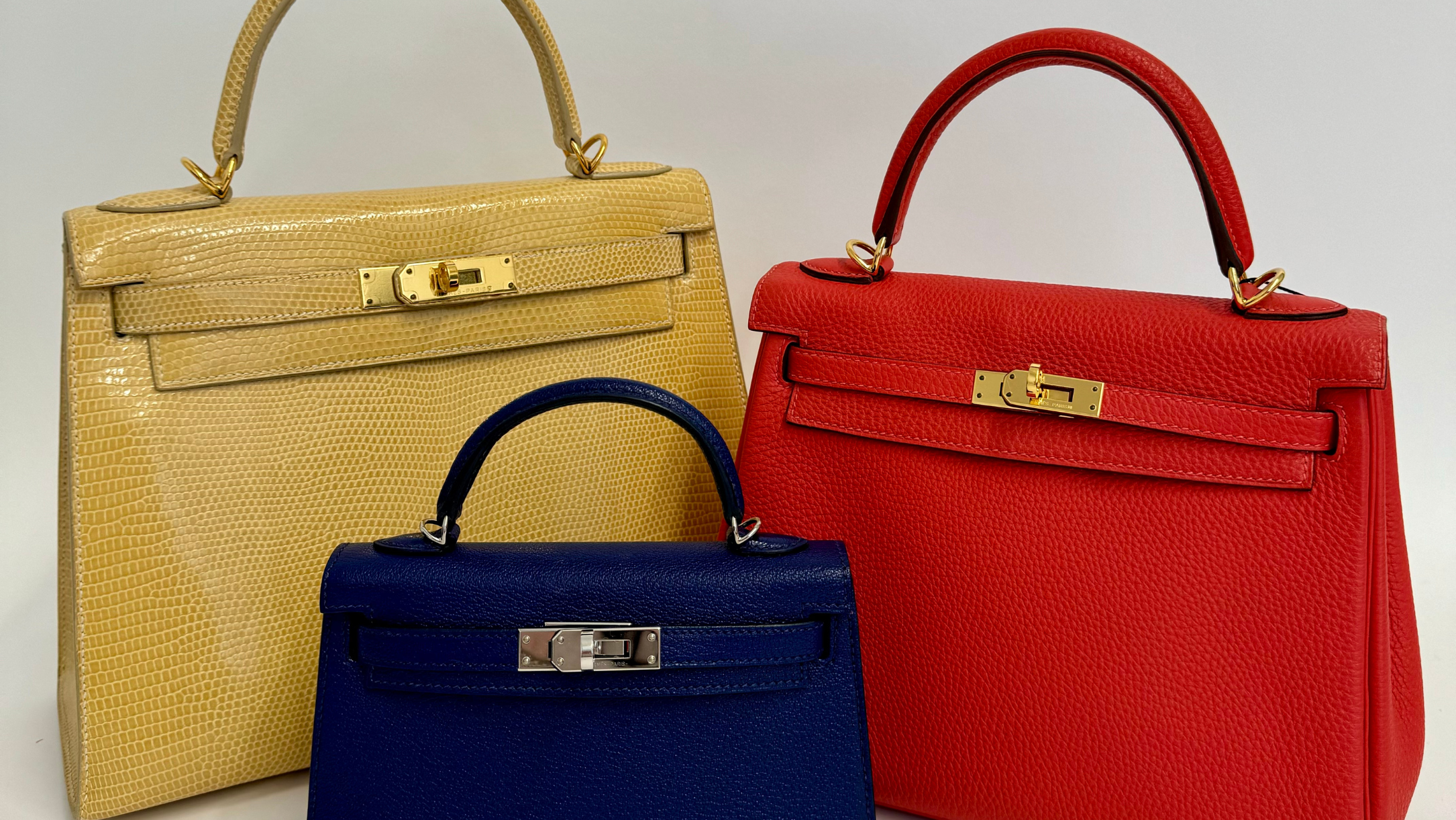 Hermès Kelly Bag Price blog post image with a yellow Kelly, red Kelly and blue Kelly on a white background