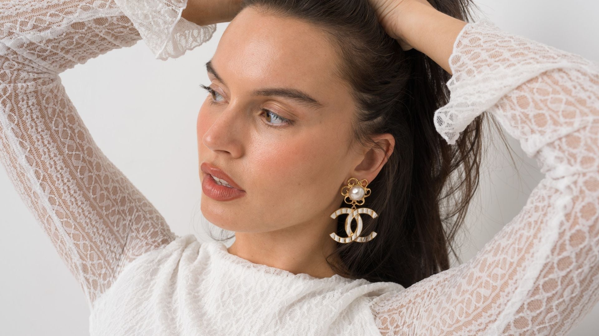 woman wearing chanel earrings