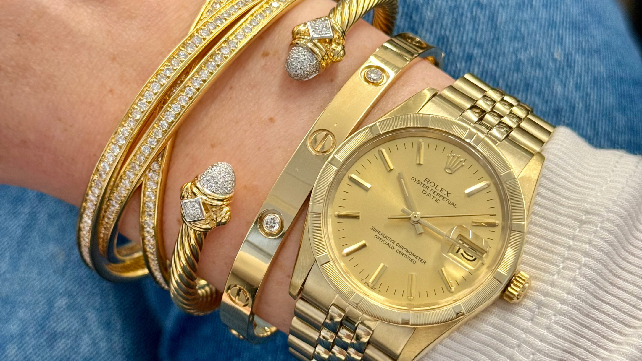 Yellow gold luxury bracelets and Rolex watch