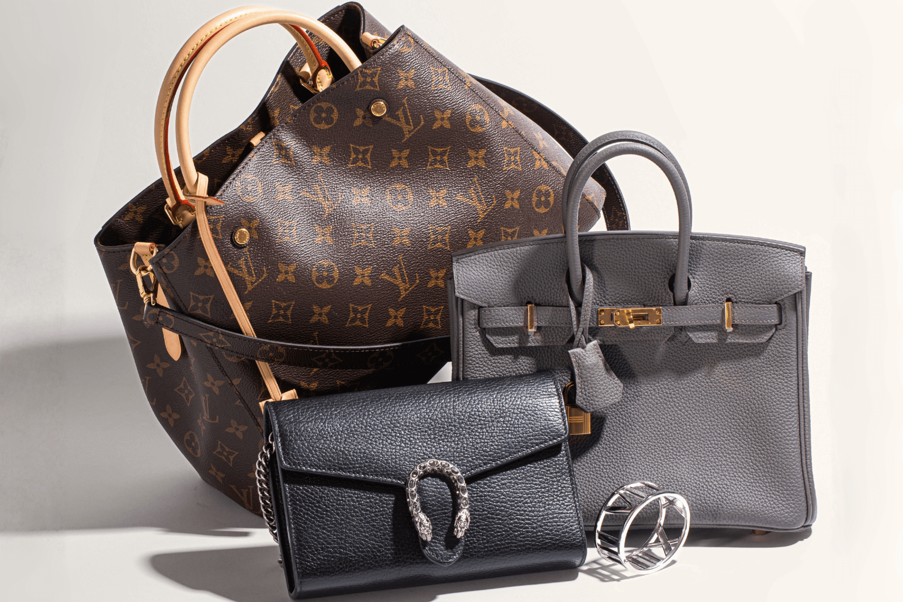 Three designer handbags and a Tiffany bracelet