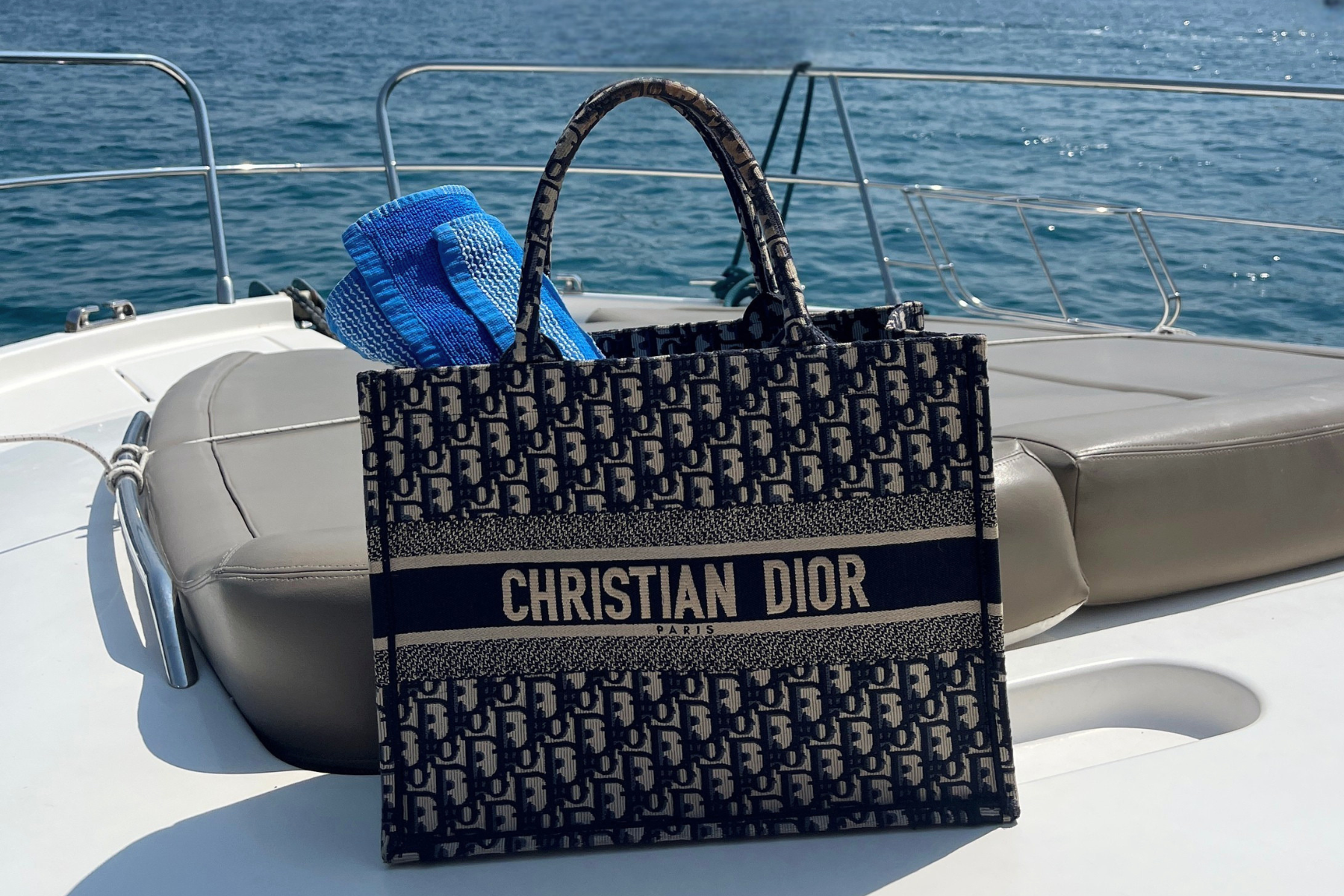 Dior Oblique blue Book Tote on a boat