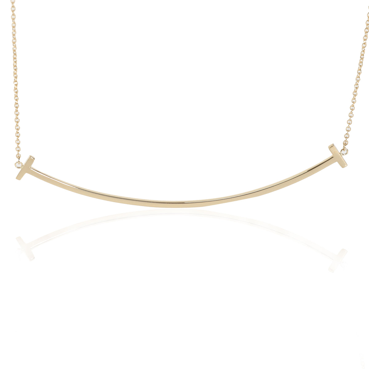 Tiffany T medium smile pendant in 18k gold with diamonds.